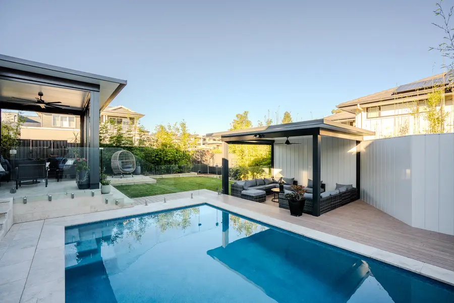The alfresco, lawn and pavilion seen together across the pool