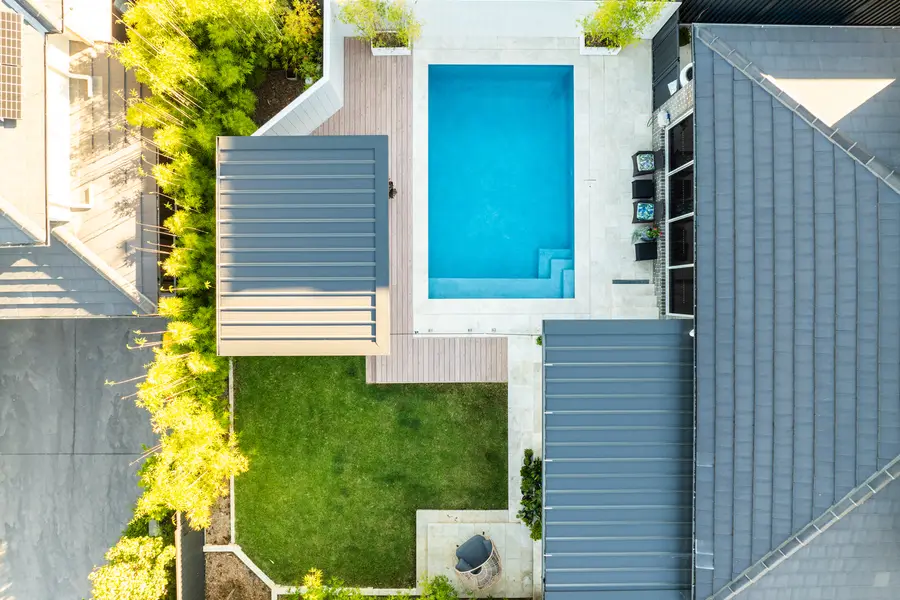 The finished backyard, alfresco and pavilion facing each other across the water