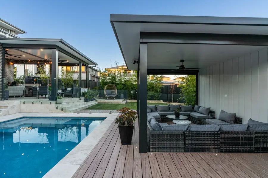The alfresco and pavilion either side of the pool as the light drops