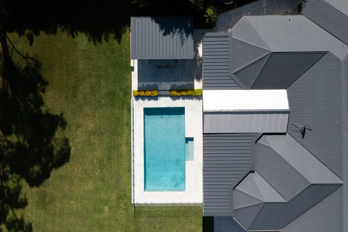 Directly overhead — the pergola and cabana roofs, pool and lawn in plan, Annangrove
