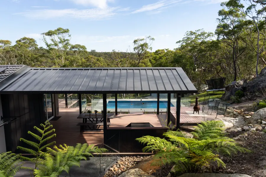 The function pergola from above — skillion roof, aluminium deck and glass balustrade over the pool