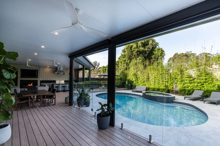 The covered deck looking out over the figure-eight pool and spa