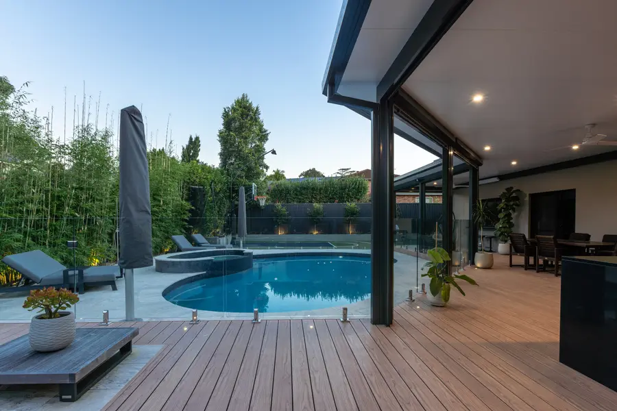 The deck stepping around the pool, with the spa and court beyond
