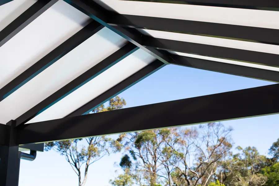 Close detail of translucent polycarbonate panels set between the black gable beams