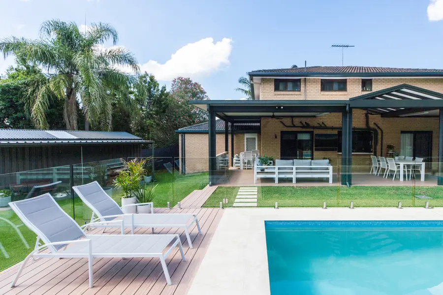 The alfresco, aluminium deck and pool seen across the water from the far corner of the yard