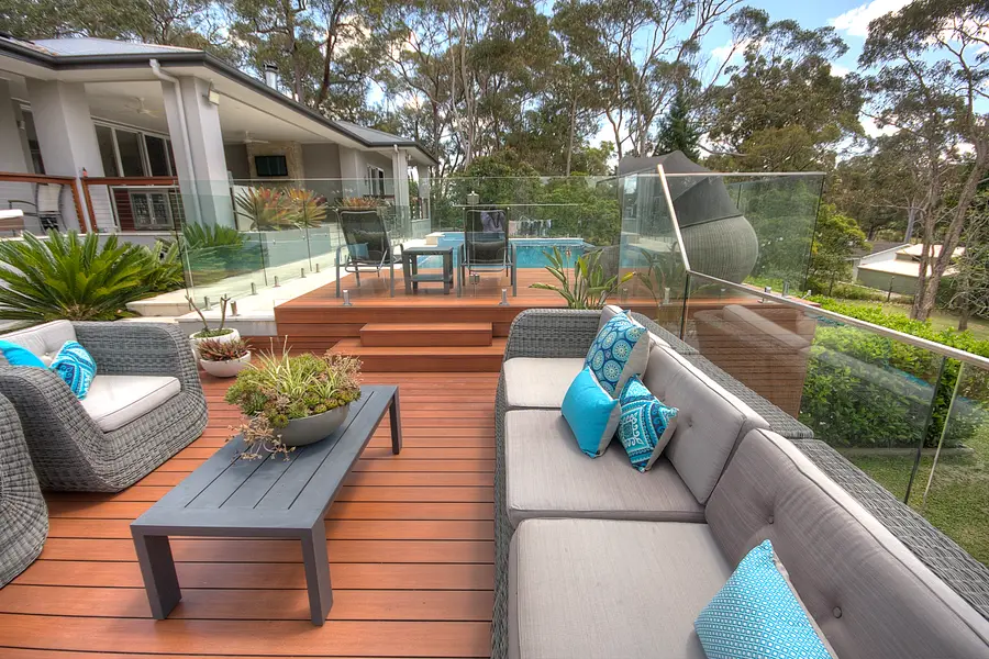 Looking across the lounge to the pool and the trees past the balustrade