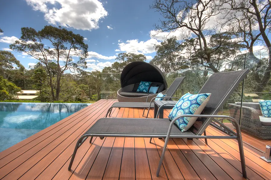 Loungers and canopied daybed at the water's edge