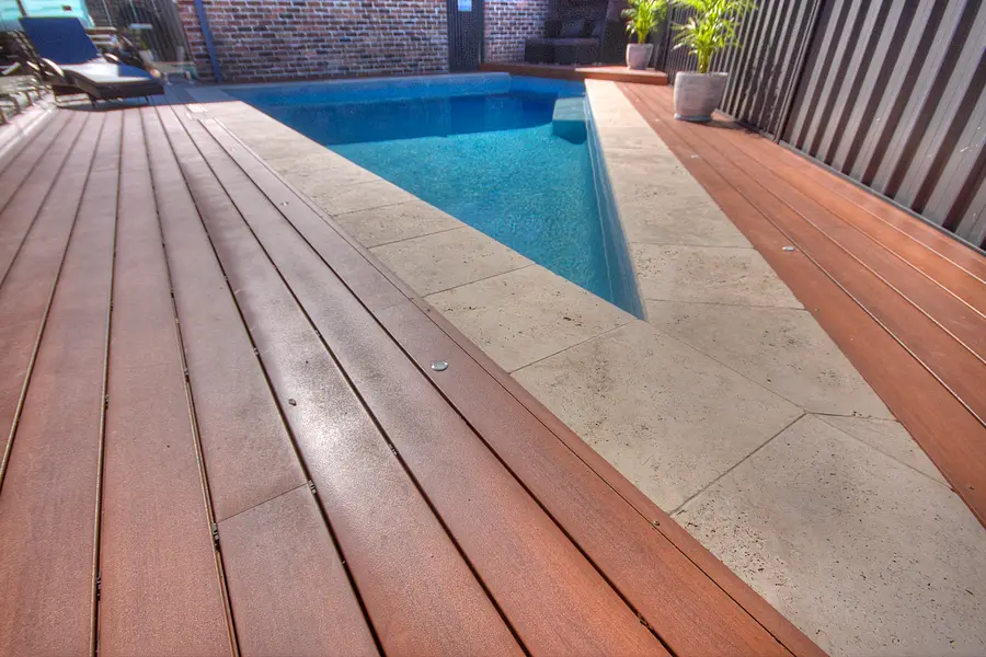 The deck meeting the pool at an angled corner, boards running to the point