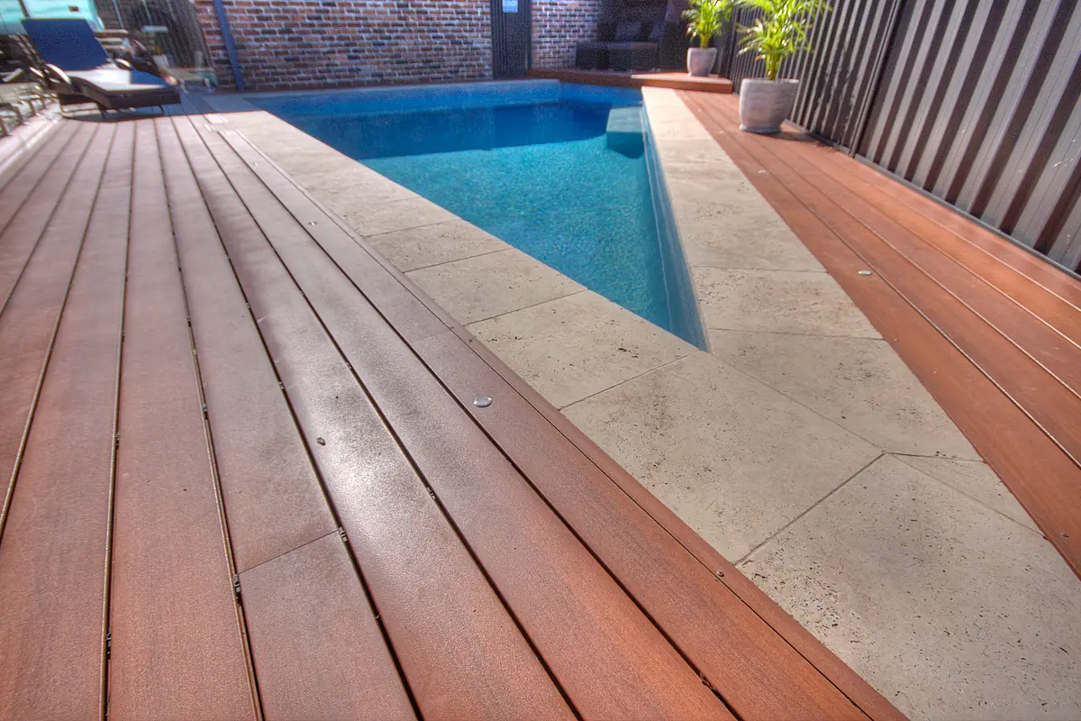 The deck meeting the pool at an angled corner, boards mitred to run into the point