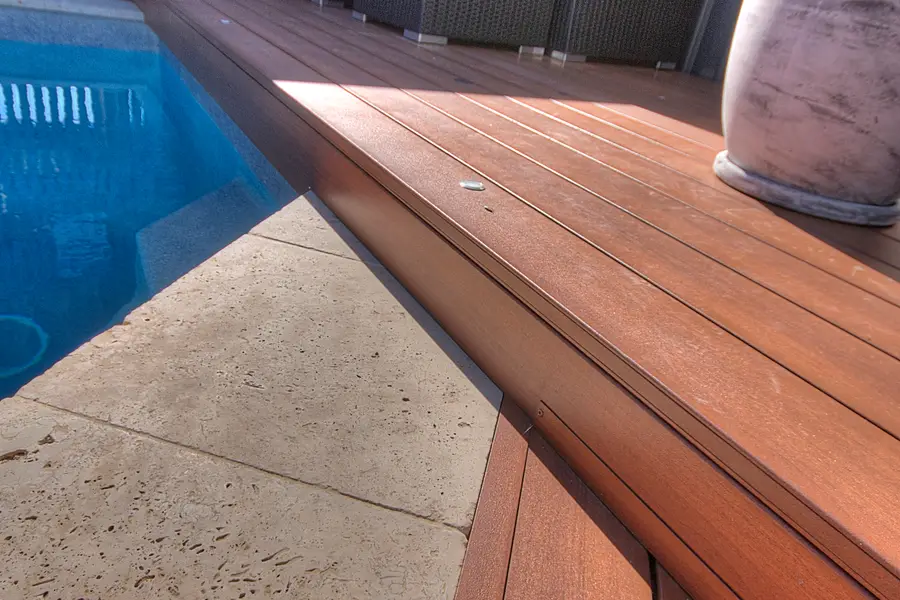The deck stepping up to a lounge area against the brick wall