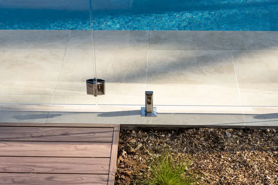 Looking down over the aluminium deck edge to the pool and its glass fence