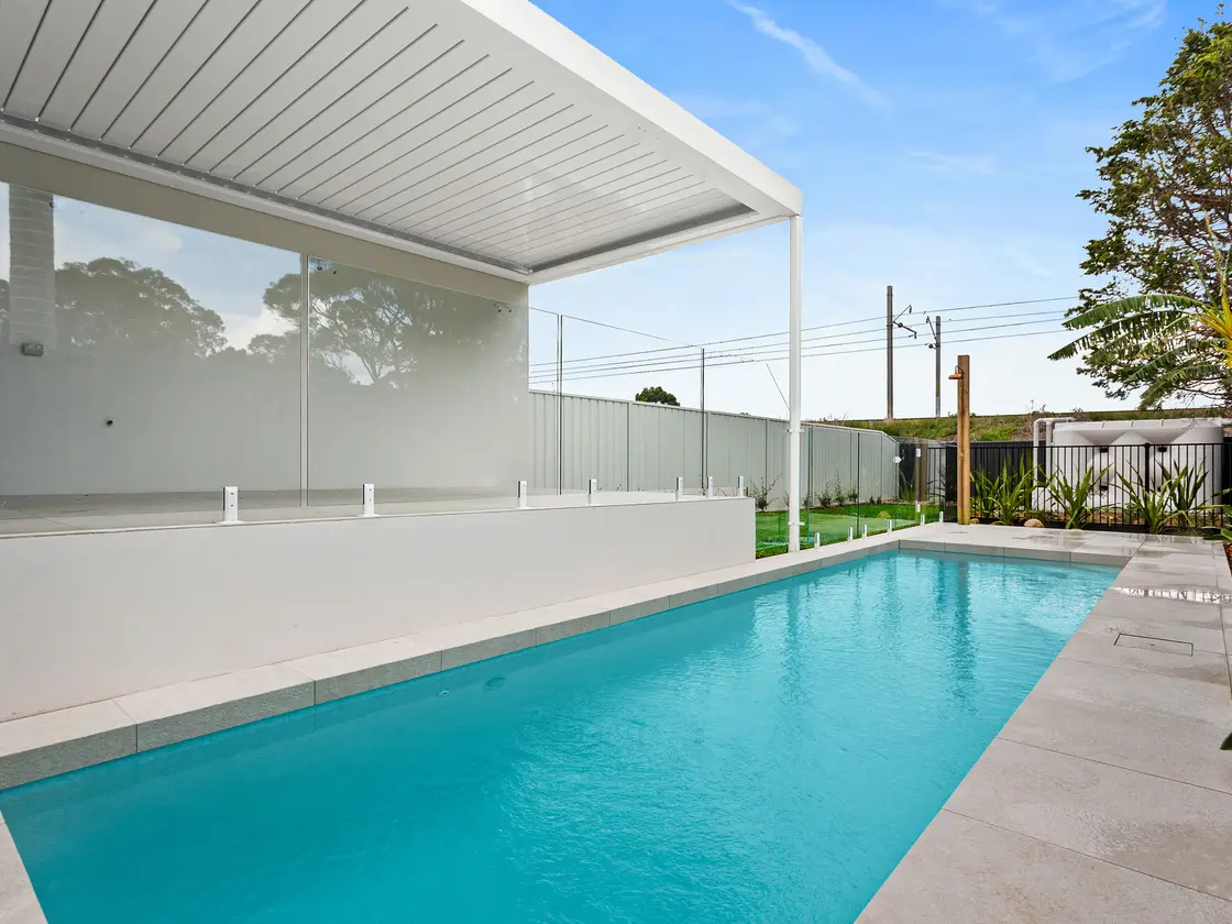 Louvred roof with the blades closed into a flat, sealed ceiling above a pool