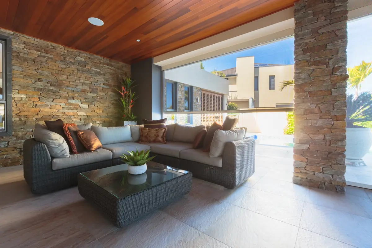 Blind fully retracted into its slim headbox above an open alfresco, leaving the opening clear
