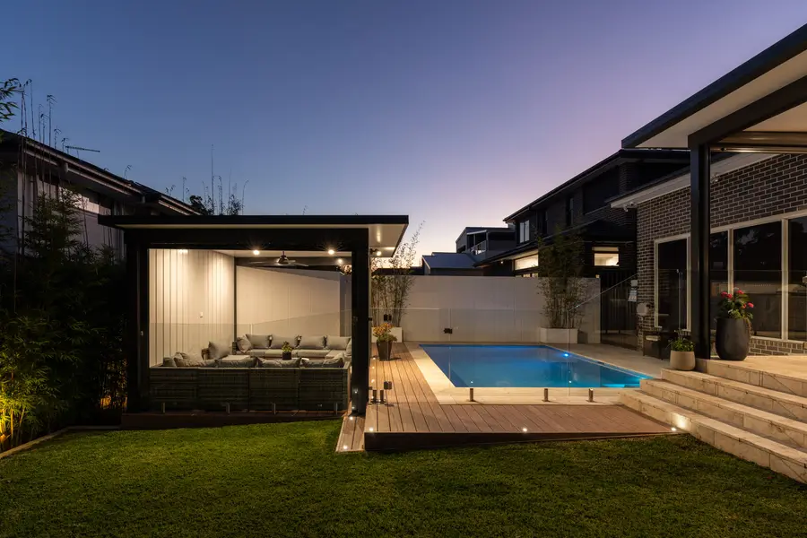 The pavilion and deck from the lawn, in-deck lights picking out the edge