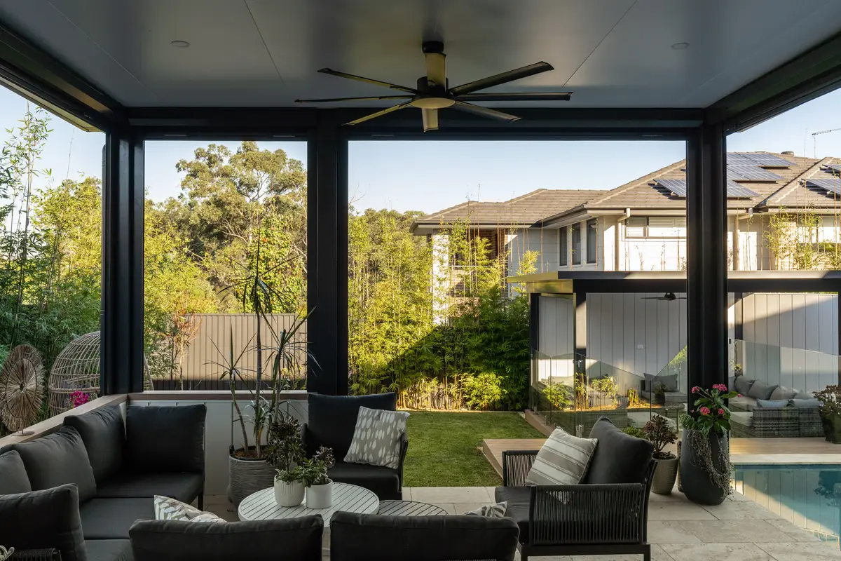 Under the alfresco with a large outdoor fan and a clad-wall servery looking out to the lawn, North Kellyville
