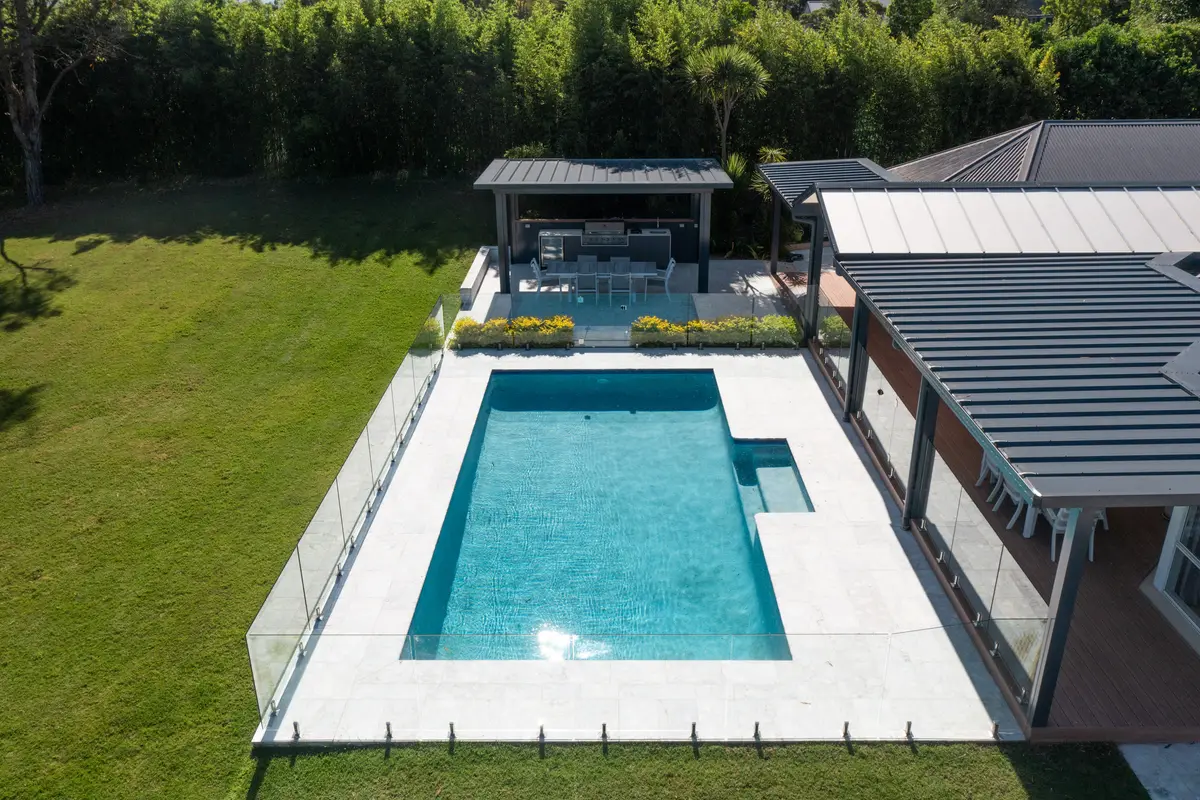 The pergola, poolside cabana and pool from above, set against the bamboo screen and lawn, Annangrove
