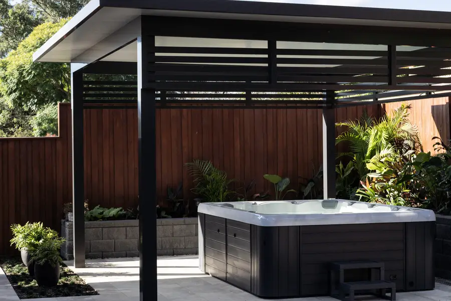 Freestanding insulated cabana over the swim spa, with aluminium slat screening above