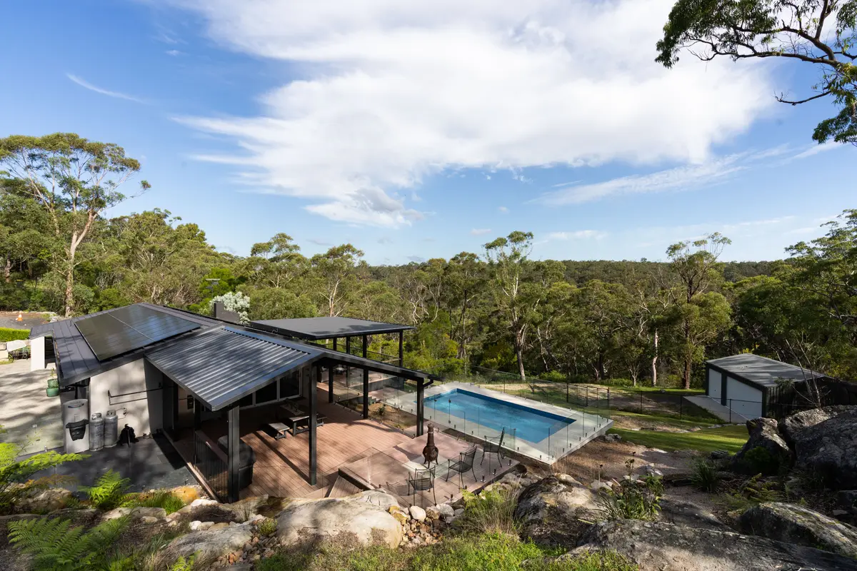 The pergola, deck and pool stepping down the block, surrounded by bushland, Galston