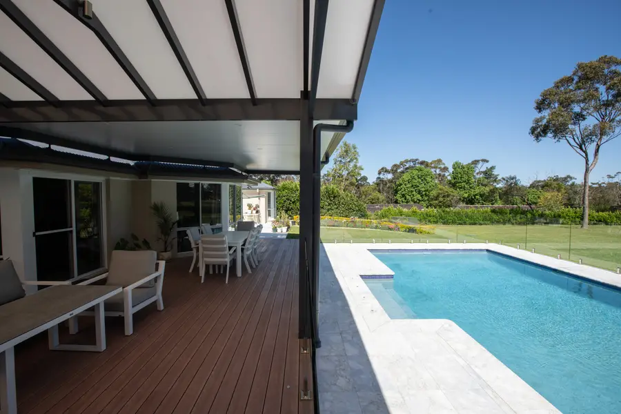 The alfresco running the length of the deck, opening to the pool and paddock beyond