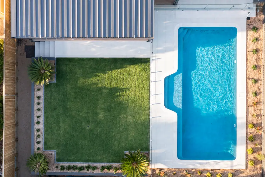 Directly overhead — pergola roof, lawn and pool in plan
