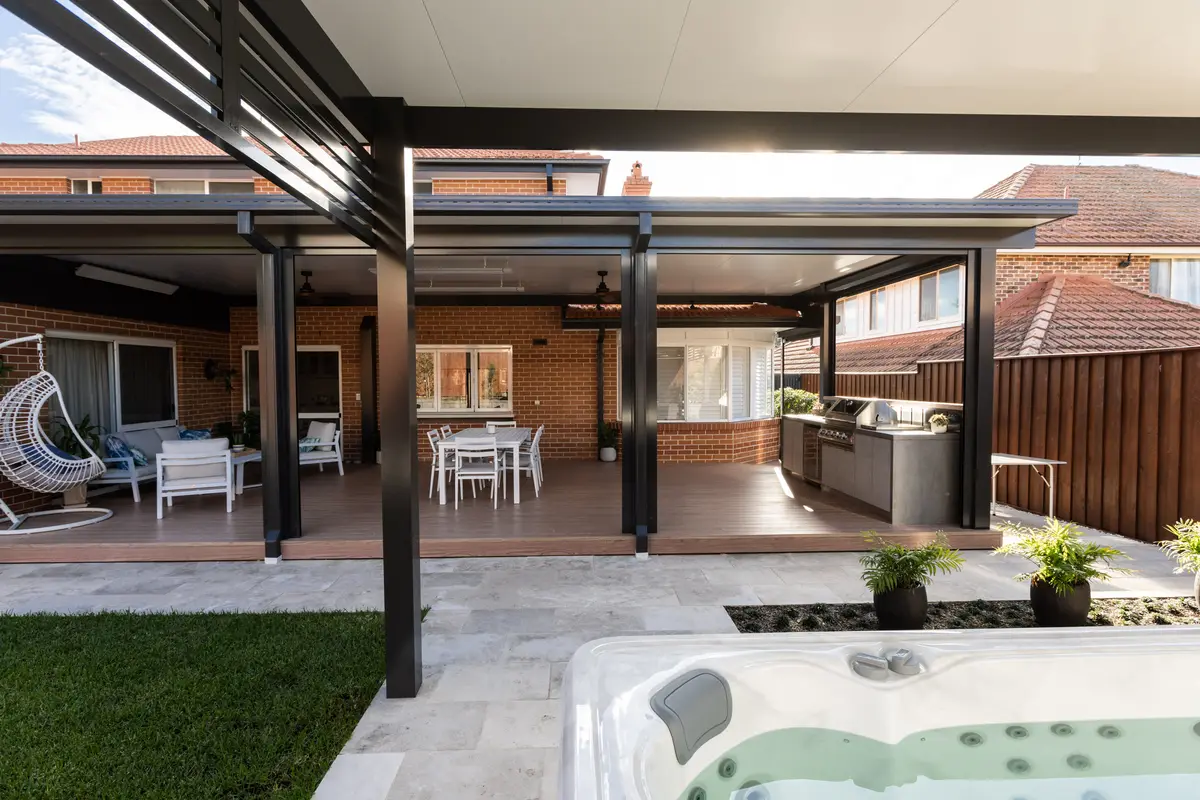 Aluminium deck and covered patio seen from the far side of the courtyard