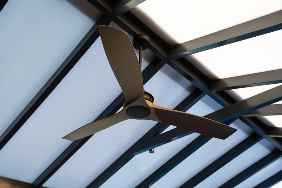 Timber-look outdoor fan against the translucent gable panels