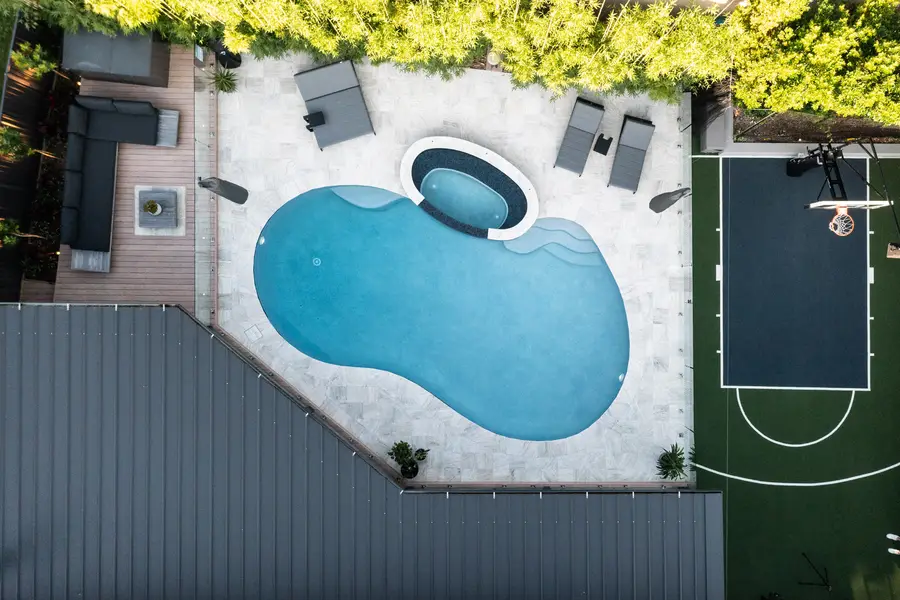 Directly overhead — the figure-eight pool and spa that give the project its name, with the deck and half-court either side