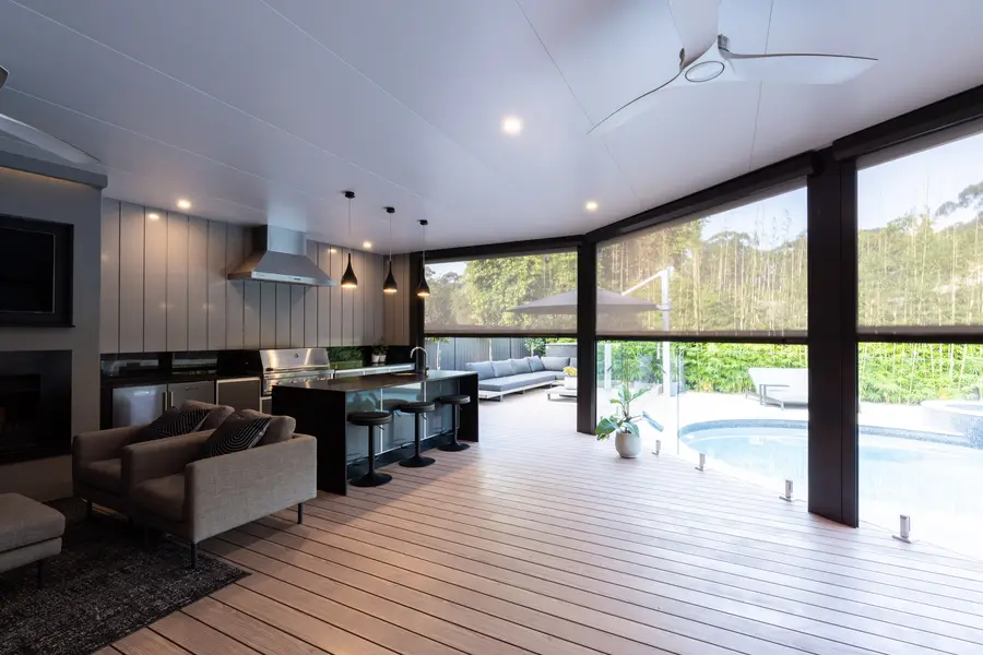 Island bench and stools, with the blinds part-drawn and the daybed beyond