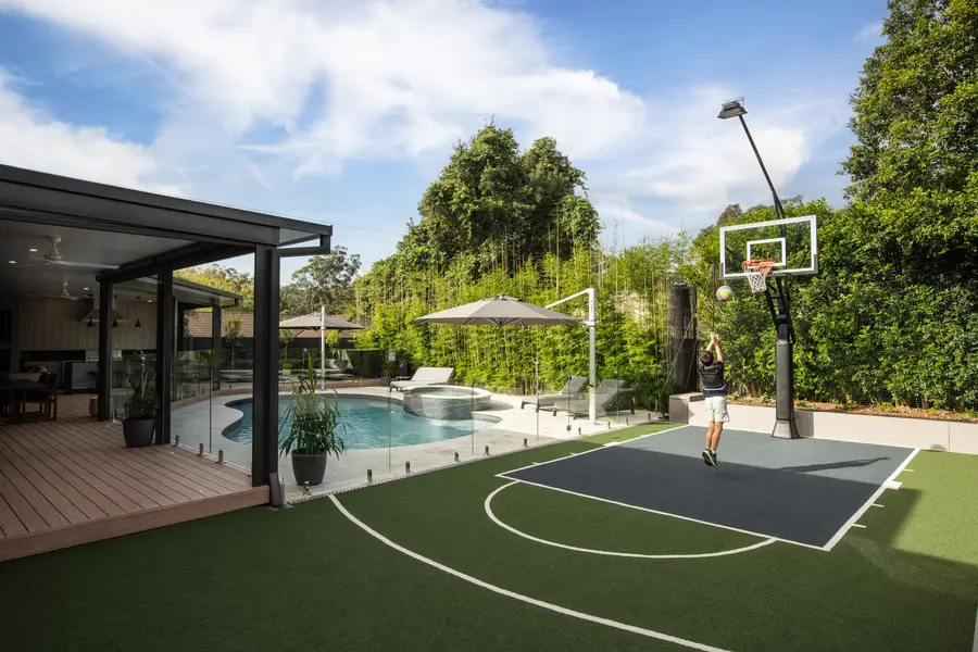 The half-court alongside the pool, with the alfresco opening onto both