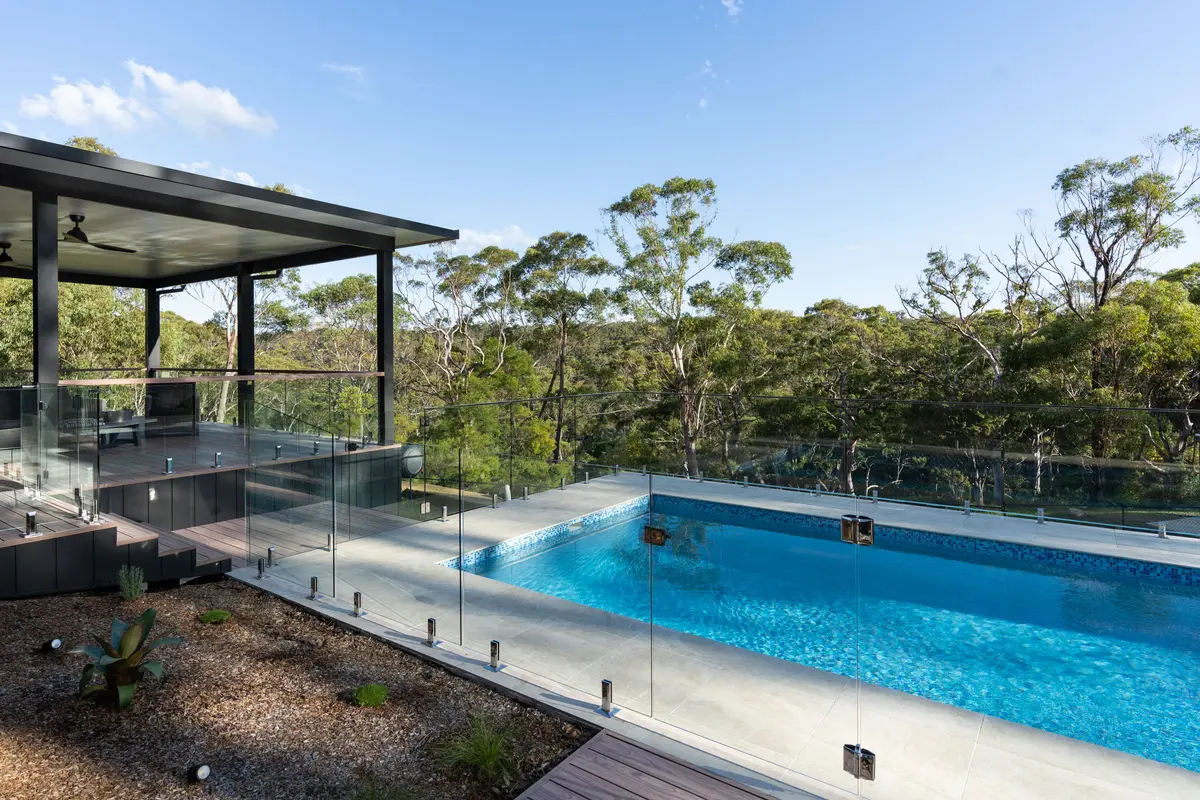 Frameless glass balustrade running along the deck and around the pool, Galston