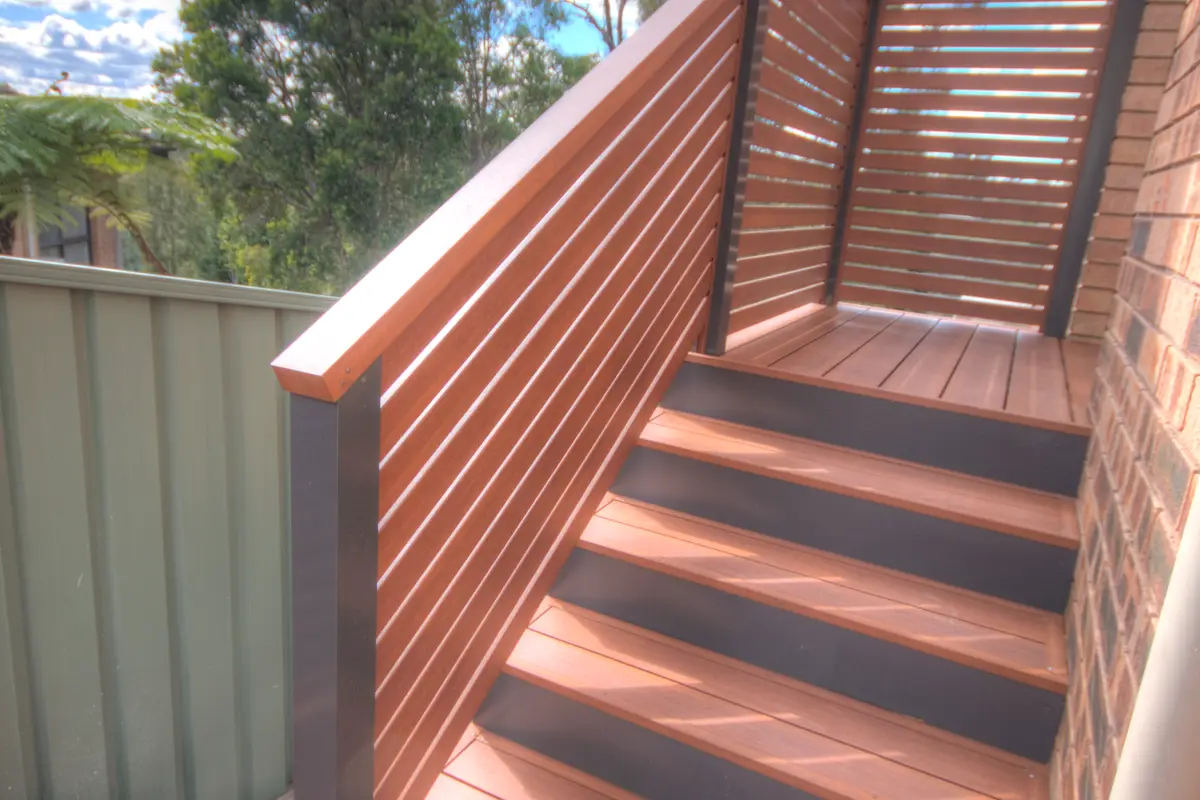 Aluminium stairs with a horizontal slat balustrade in a timber-look finish running up beside the treads